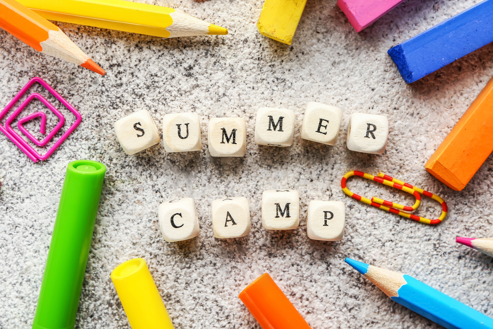Words SUMMER CAMP Made of Cubes, Pencils and Crayons on Table